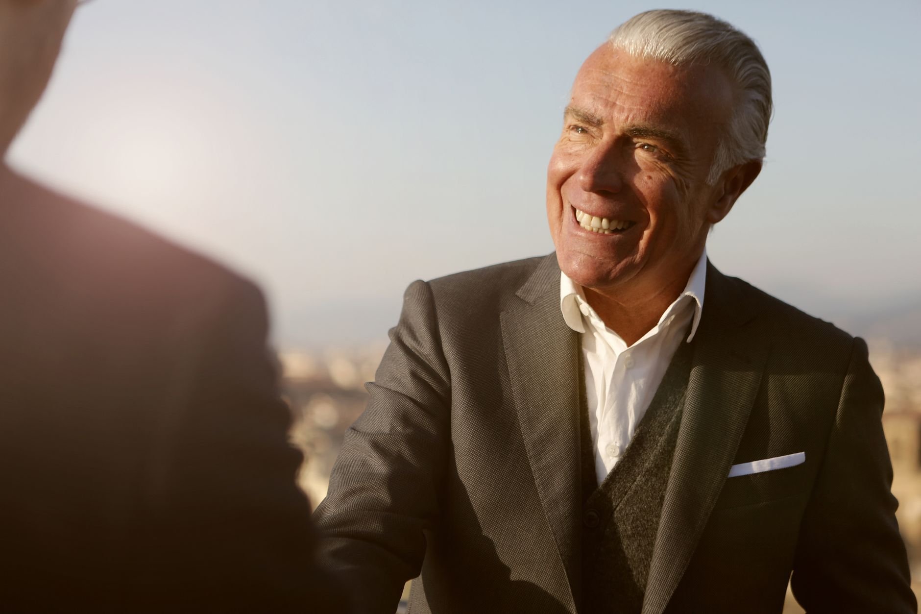 Trusted advisor in a warm, professional meeting — engaged and attentive